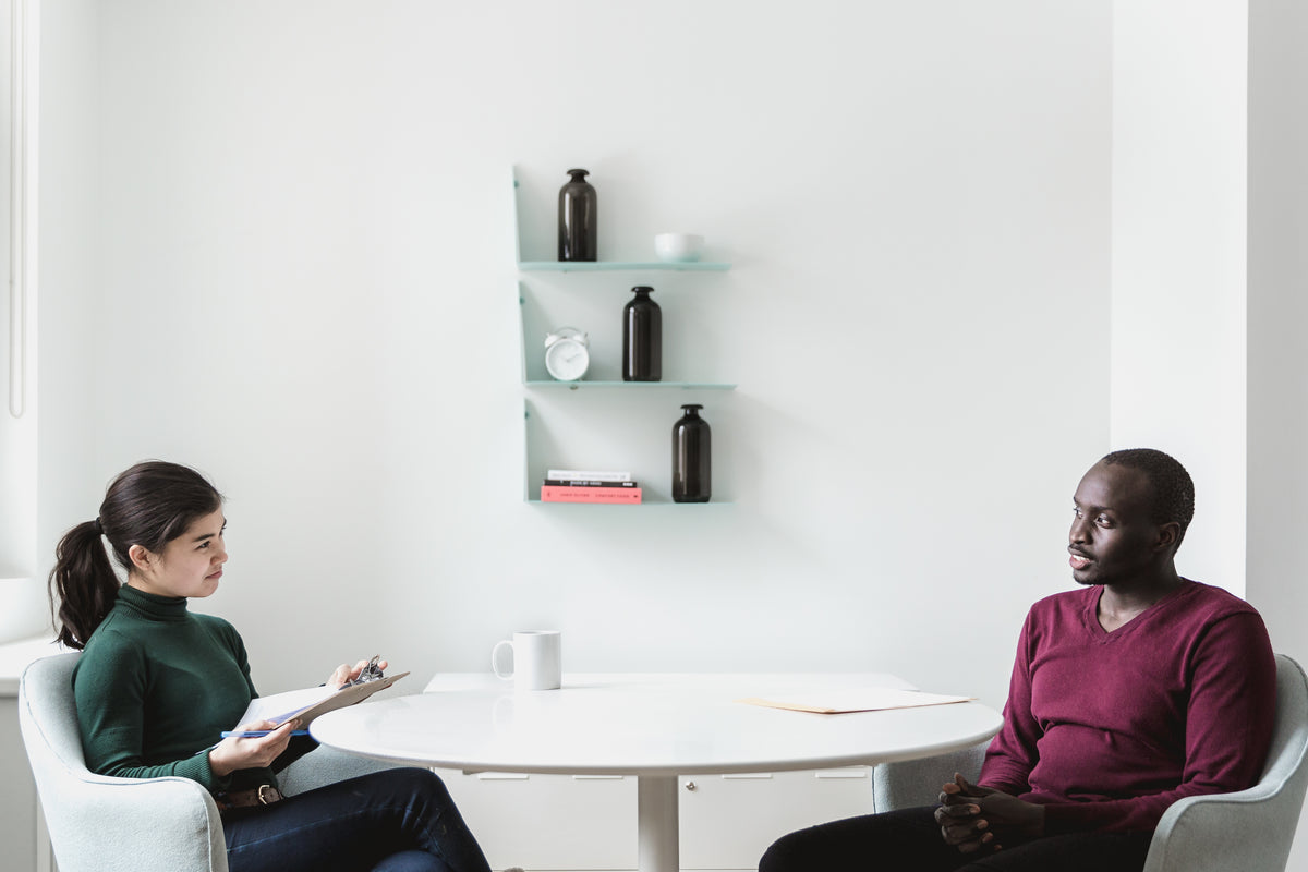 Two people discussing support plans during a consultation